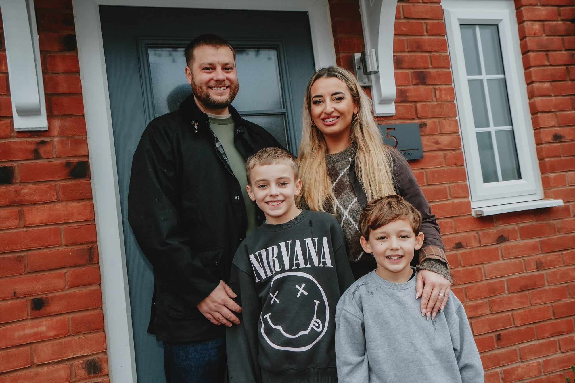 The Baldwins stood outside their new home, The Birch, at The Laurels in Brailsford, Derbyshire