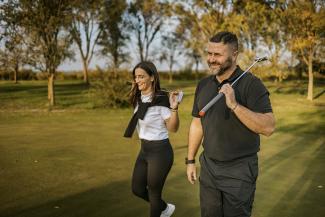Man and woman playing golf