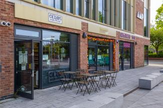 Exterior shot of Cleo's Deli and other shops in Arnold