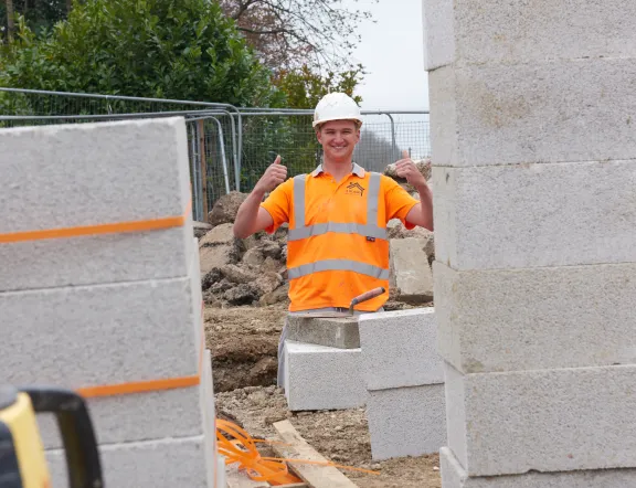 man standing with his thumbs up