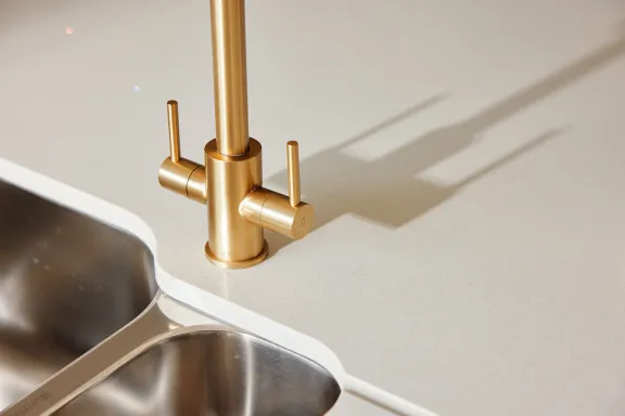 Close up of gold tap and basin