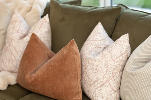 Close up of cushions and throw on sofa