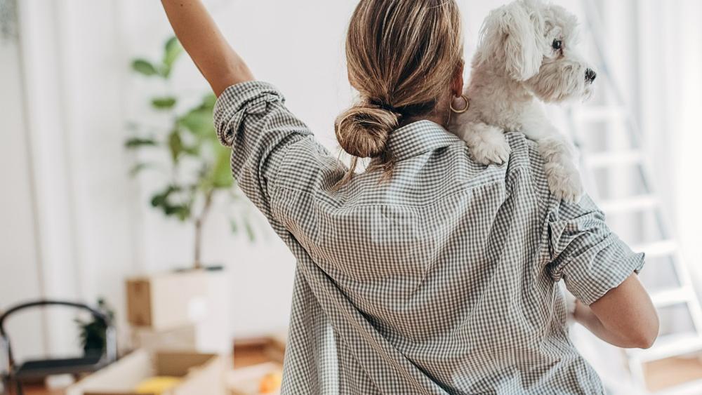 Woman with dog entering new home