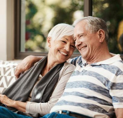 Older couple sitting on a sofa in a nice home