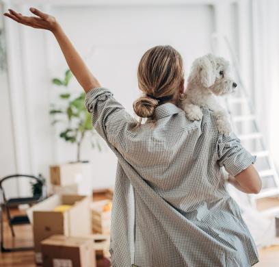 Woman with dog entering new home
