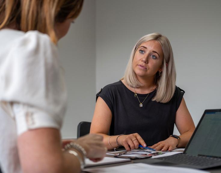 2 ladies in office talking to each other 2 ladies in office talking to each other