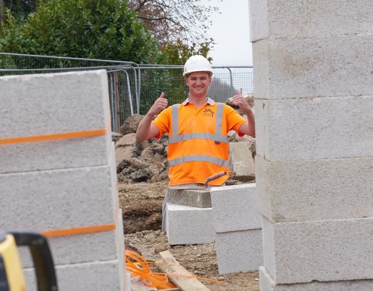 Man standing with his thumbs up.