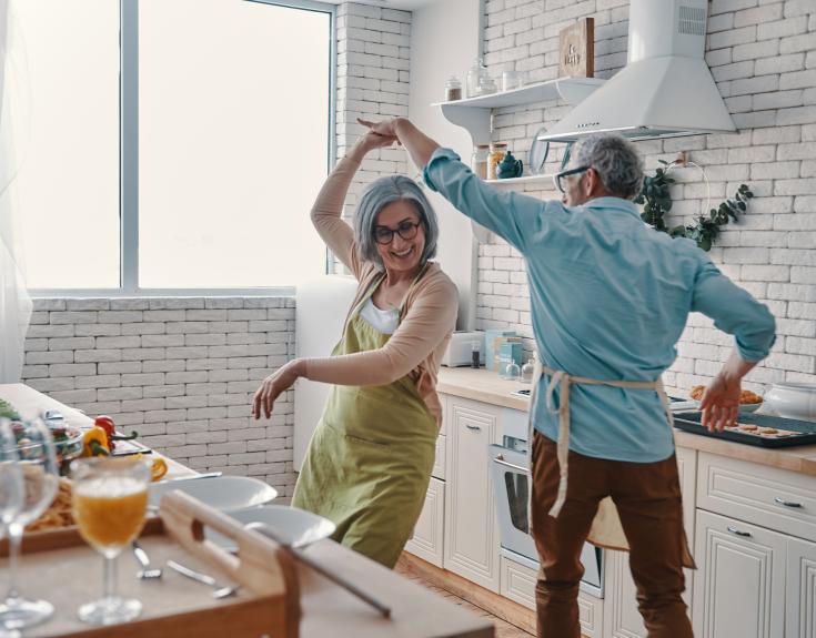 happy couple dancing in kitchen